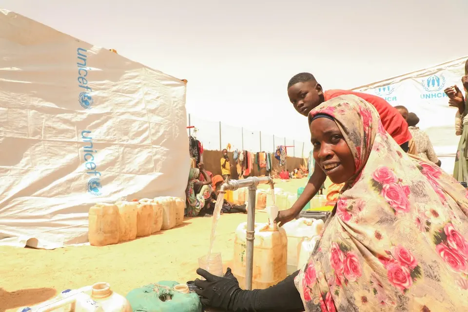 A Sudanese refugee fetches water from a waterpoint set up by UNICEF at a temporary relocation site in Tiné, eastern Chad.