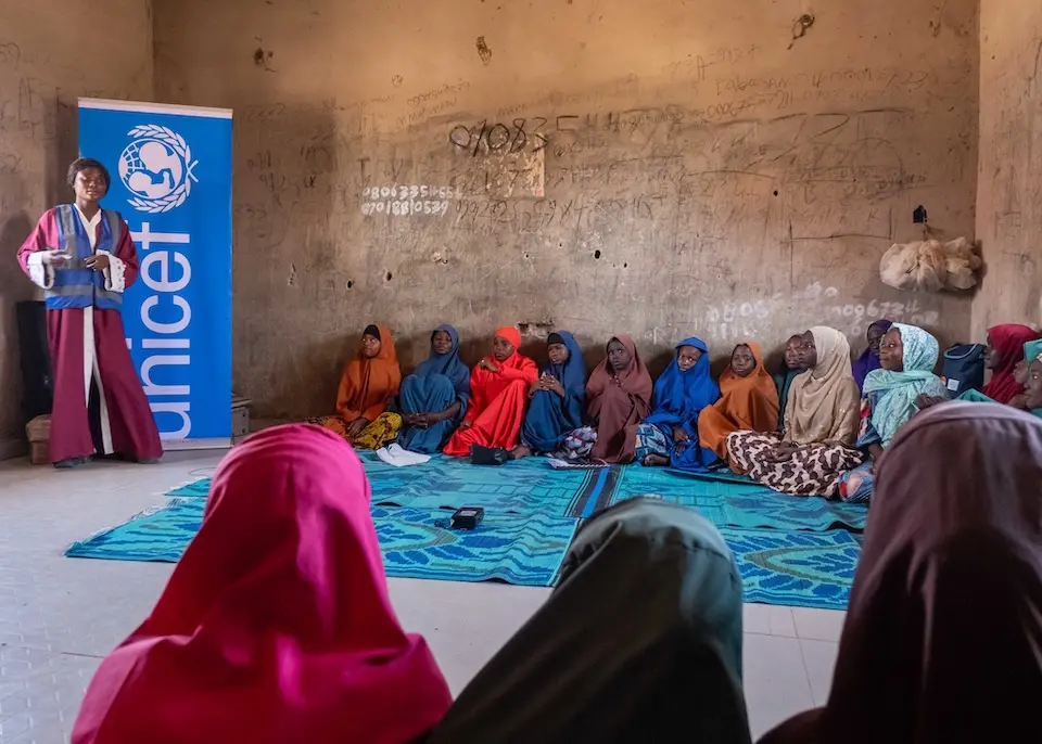 Students seated on the floor take part in a lesson in Gubio Camp, Maiduguri, Borno State, Nigeria.