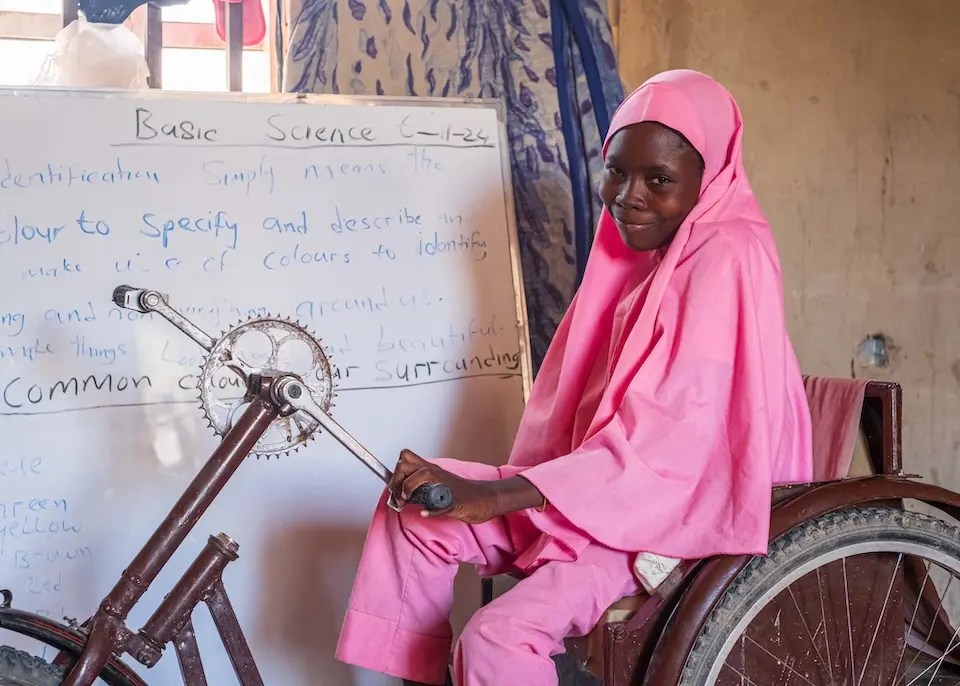 sits on her wheelchair, provided by UNICEF with funding from Education Cannot Wait, in her classroom in Maiduguri, Nigeria.