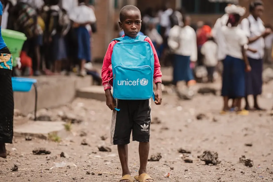 A boy in Goma, North Kivu province, DR Congo, carries a school bag of learning supplies provided by UNICEF.