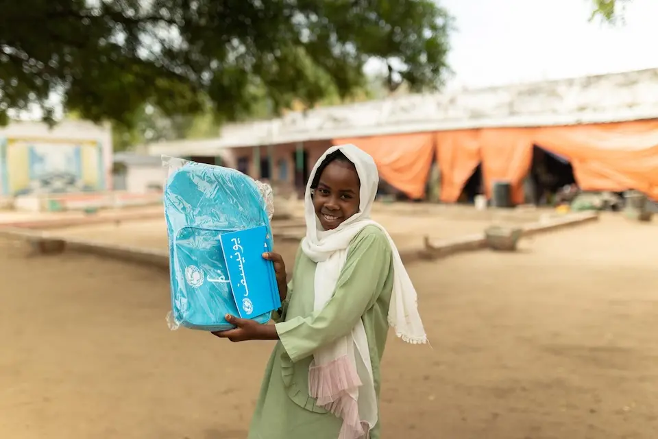 A 10-year-old students shows off her new UNICEF school kit in Blue Nile state, Sudan.