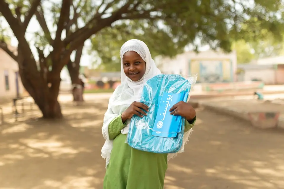 A 10-year-old holds her UNICEF backpack in Blue Nile state, Sudan.