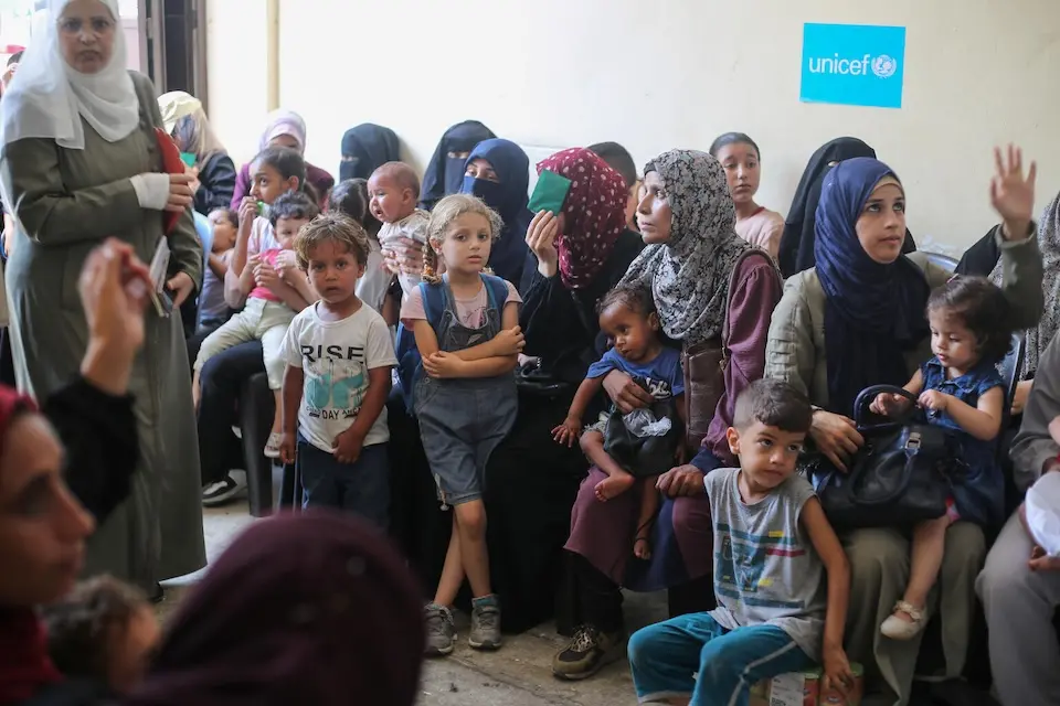 Mothers and children wait to be seen at a UNICEF-supported nutrition clinic in Deir al Balah, Central Gaza.