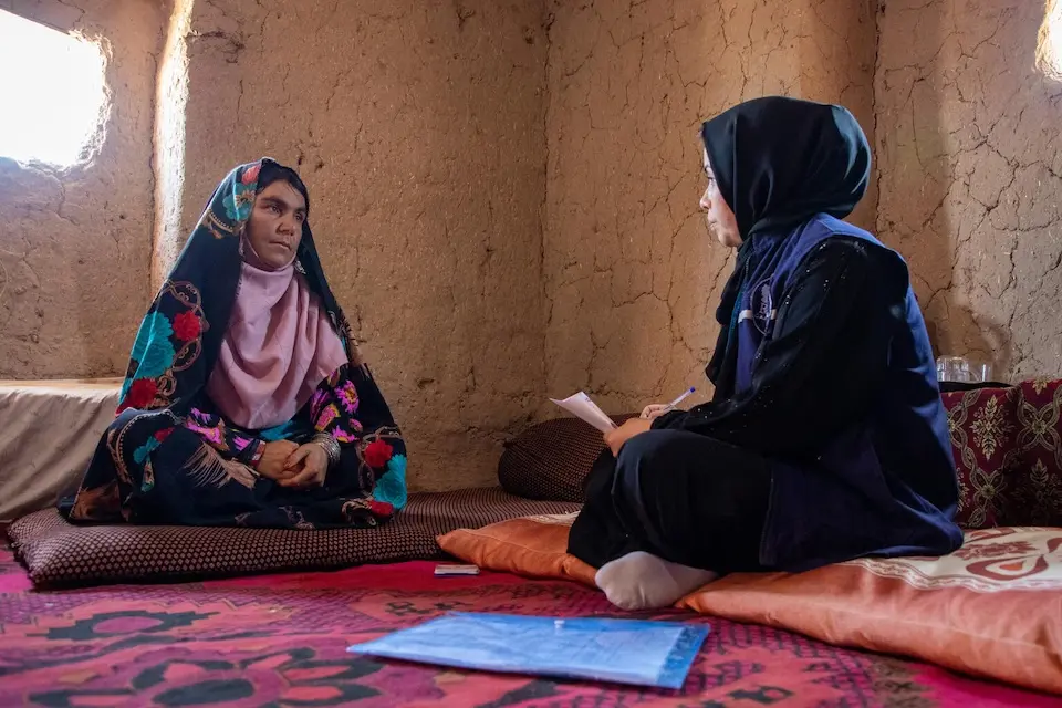 In Herat province, Afghanistan, a UNICEF-supported social worker, right, meets with a woman to persuade her not to push her 12-year-old sister-in-law into an arranged marriage. 
