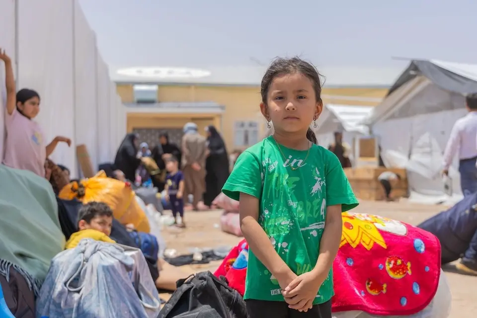 Anisa, 6, sits beside her family's belongings &nbsp;in the reception area at the Islam-Qala border crossing after returning to Afghanistan from Iran. 