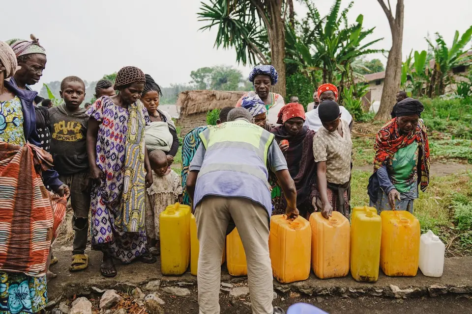 In North Kivu, Dr Congo, women and children bring jerrycans of water to be treated.