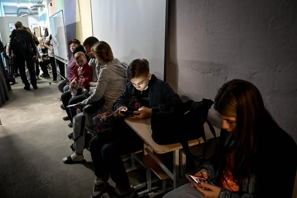 In Zaporizhzhia, Ukraine, students wait in the hallway of their UNICEF-supported learning recovery center for the end of an air raid alert before heading home.