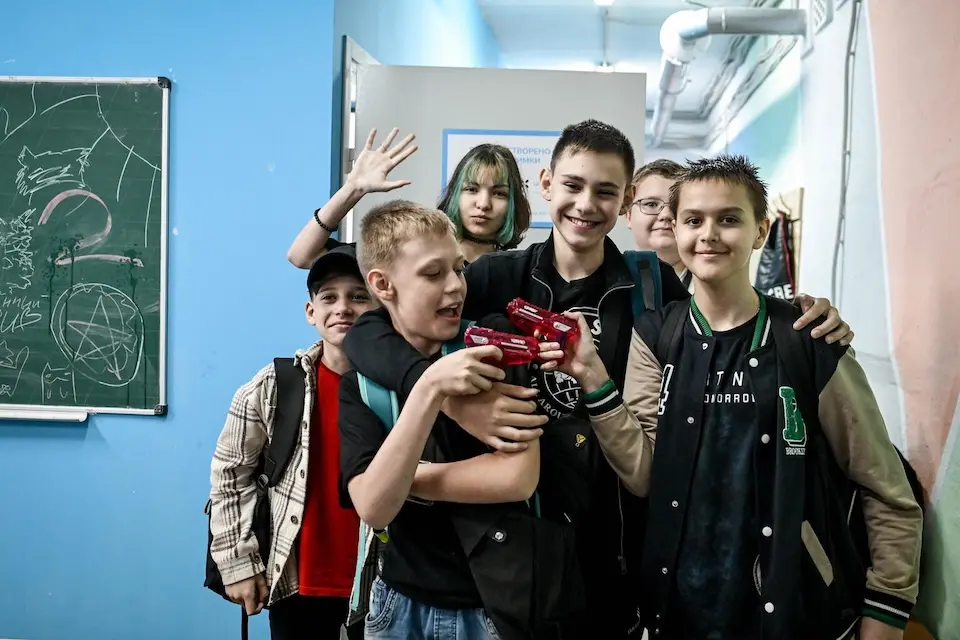 A group of secondary school pupils arrive at the digital learning recovery center launched by UNICEF in partnership with the savED Foundation in Zaporizhzhia, Ukraine .
