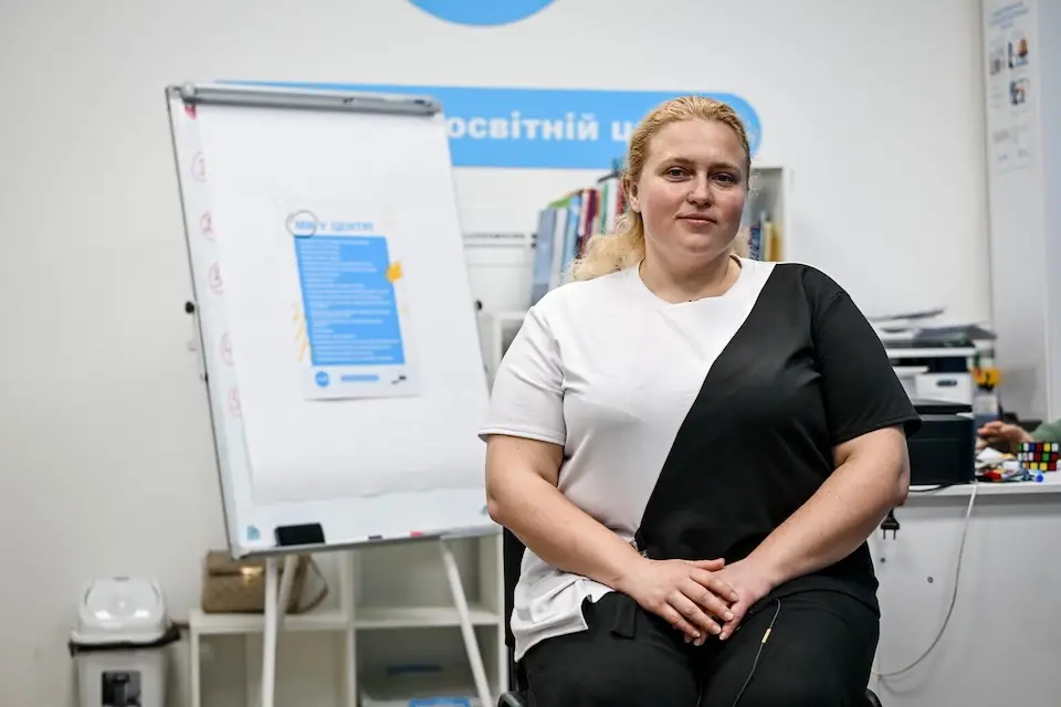 A mathematics and IT tutor sits in the digital learning center where she supports children enrolled in a UNICEF-supported catch-up education program in Zaporizhzhia, Ukraine. 