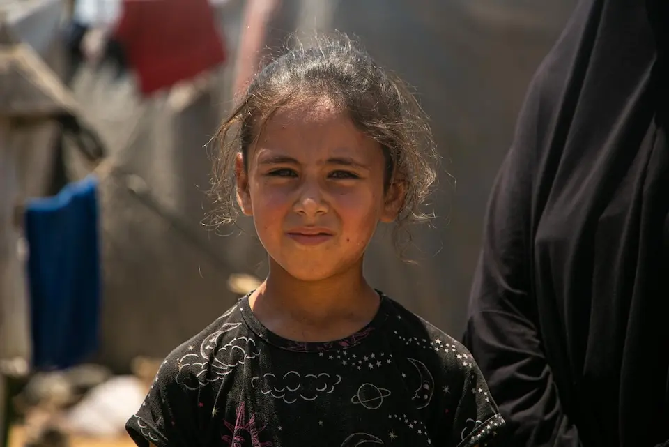 Siham in front of the tent where she lives with her family in the Gaza Strip.