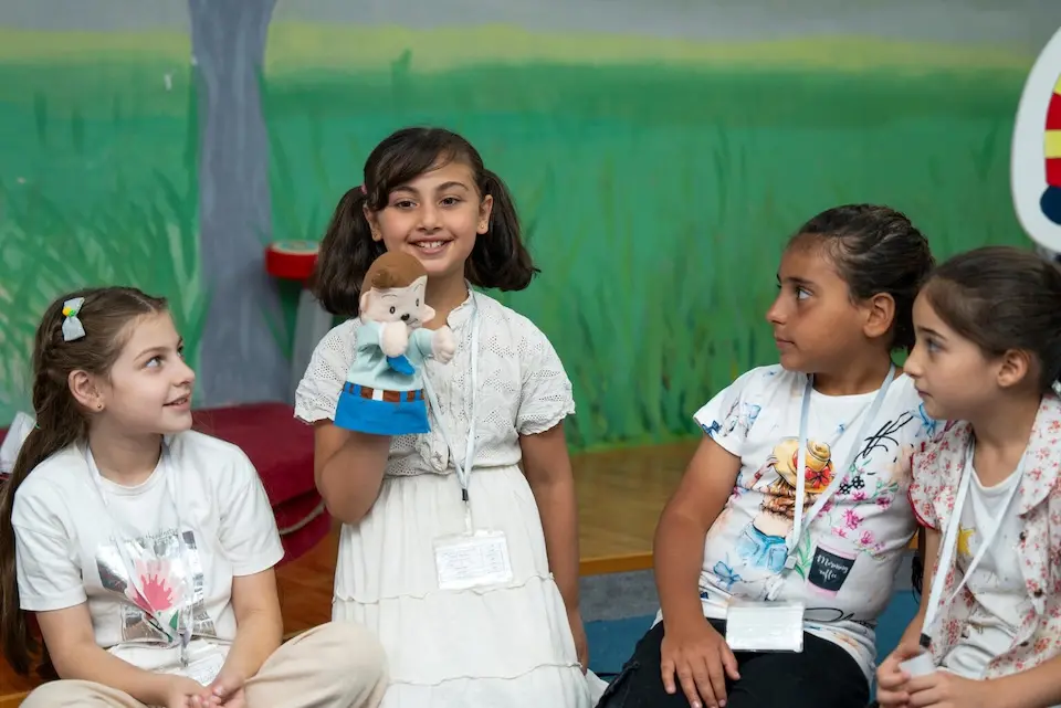 Tasneem, 11, holds a puppet while attending a psychosocial support session on expressing feelings at a UNICEF-supported child-friendly space in Damascus, Syria, on July 17, 2025.