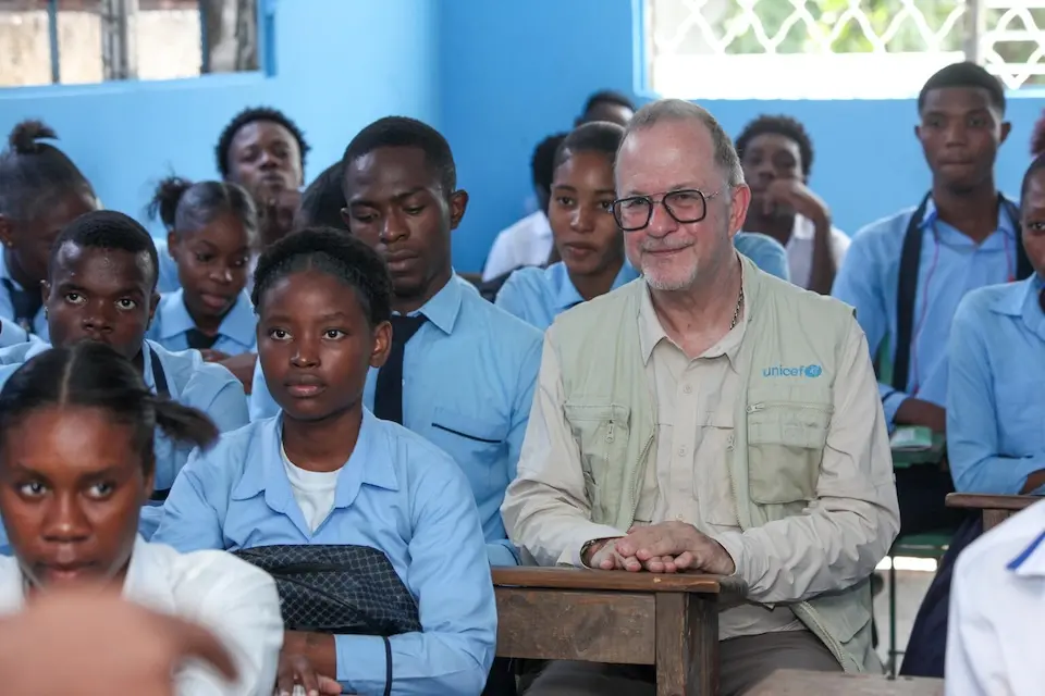 UNICEF Deputy Executive Director Ted Chaiban sits in a classroom with students in a school in Port-au-Prince, Haiti.