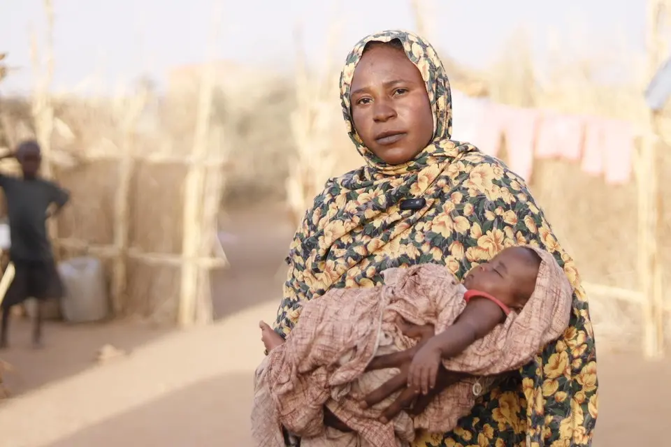 A mother holds her baby in a displacement site in Tawila, Sudan.