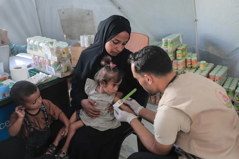 A child is screened for acute malnutrition at a UNICEF-supported outpatient nutrition treatment center in Gaza City on Aug. 26, 2025.