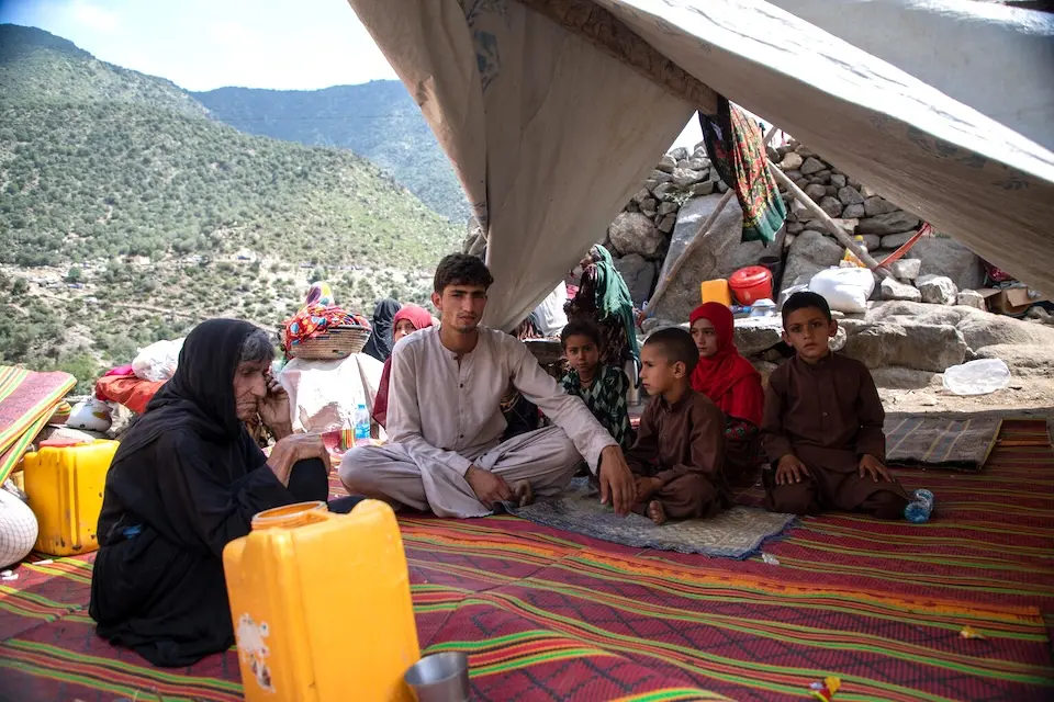 A 17-year-old with his family under a tent after the earthquake in Ghazi Abad village, Nurgal district, Kunar province, Afghanistan.