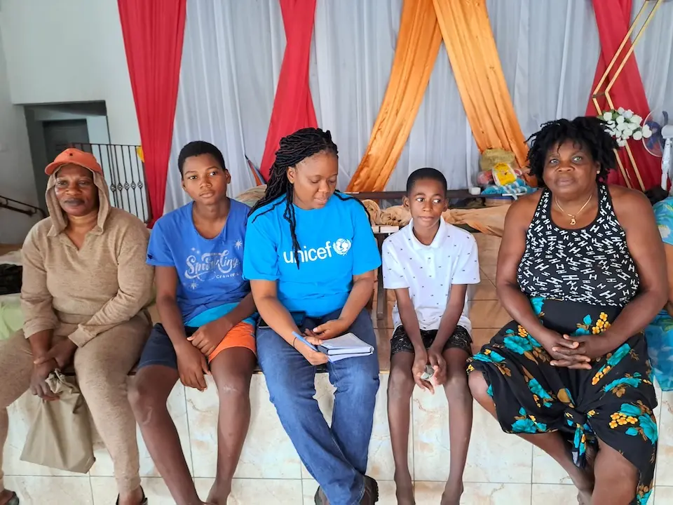 Youth talk to a UNICEF staff person about how Hurricane Beryl has affected them.