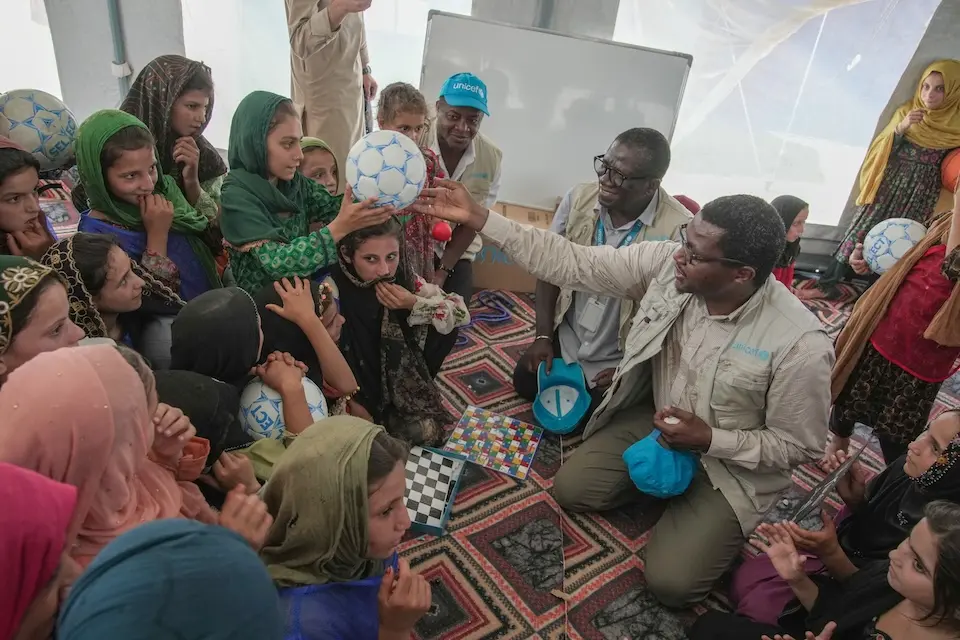 UNICEF staff joins children at a child-friendly space in Afghanistan.