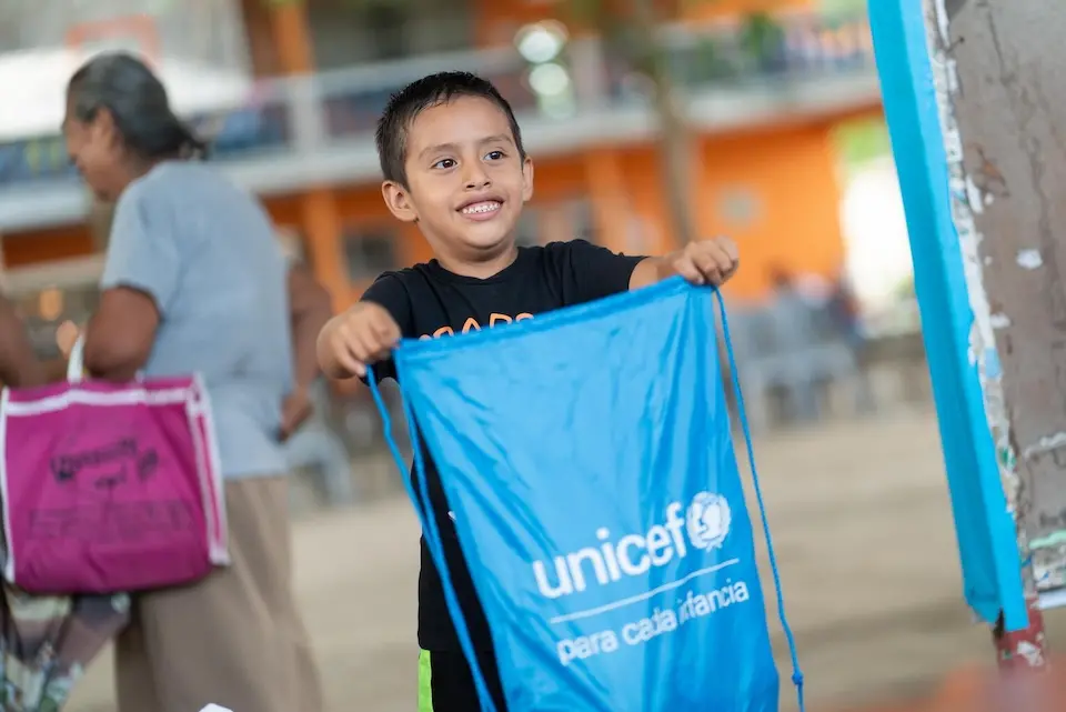 A boy in Mexico holds a personal hygiene kit provided by UNICEF after severe flooding