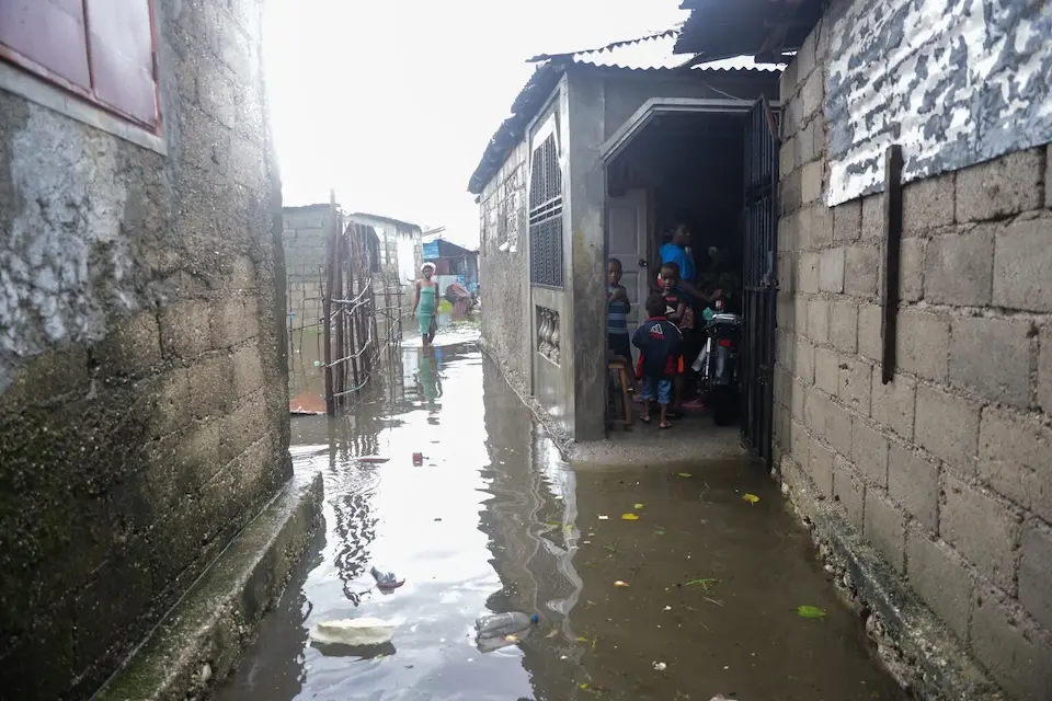 Children stand in the doorway of their flooded house after Hurricane Melissa passed through the neighborhood of Lylette in Les Cayes in the south of Haiti.