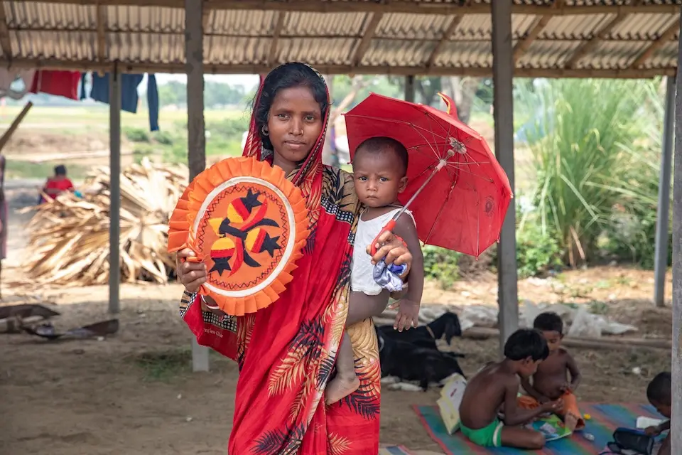 A mother fans her son to protect him from an intense heat wave in Bangladesh