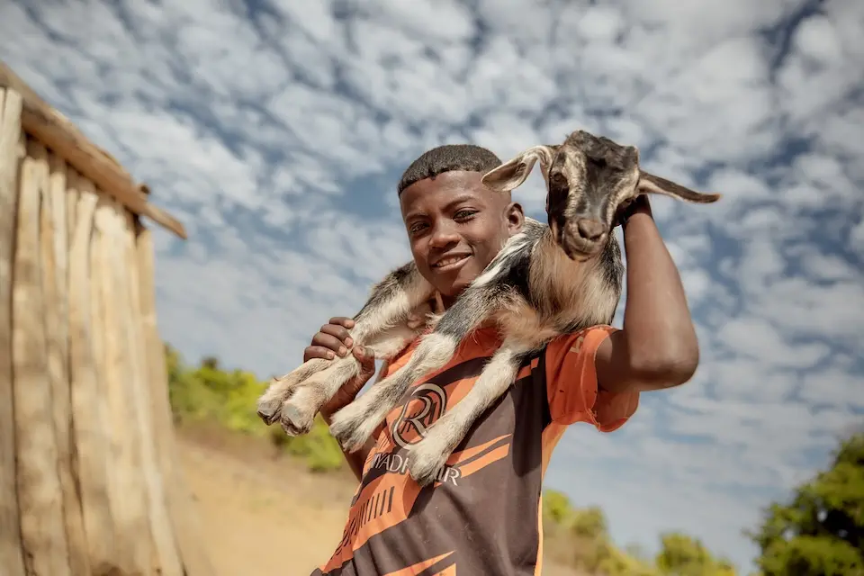 Tolotra, 12, holds a goat acquired through a UNICEF-supported community program helping to improve food and nutrition security in Madagascar.