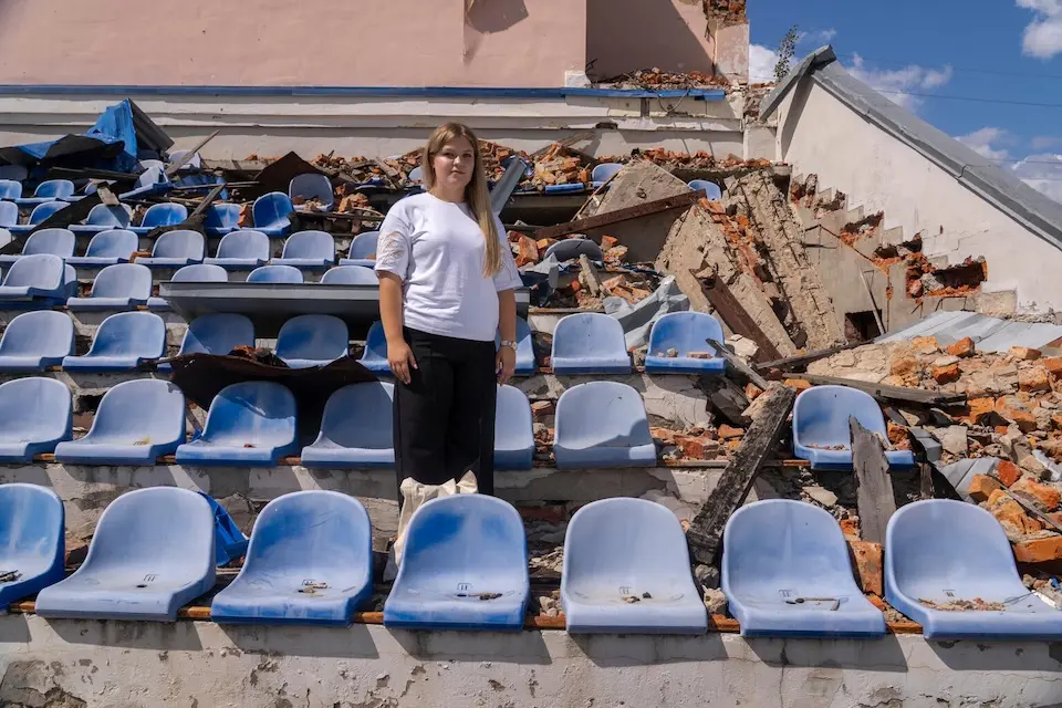 A 17-year-old girl stands in a stadium damaged by shelling Kharkiv, Ukraine. 
