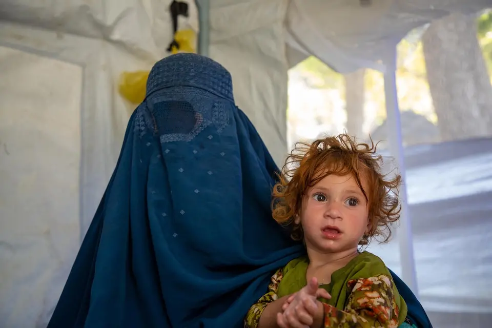 A mother in Afghanistan and her daughter, seeking medical treatment following a powerful earthquake