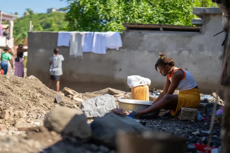 A young girl sits by what remains of a home destroyed by Hurricane Melissa in Petit-Goâve, Haiti.