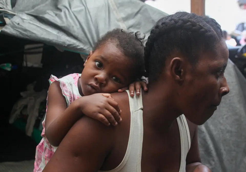 A mother and daughter outside their shelter at a UNICEF-supported displacement site outside Port-au-Prince, Haiti.