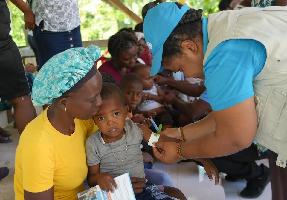 A child gets screened for malnutrition by a member of a UNICEF-supported mobile team in Boucan Carré, Haiti.