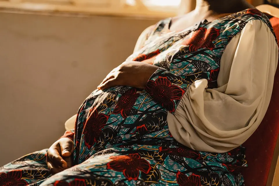 A 17-year-old pregnant survivor of sexual violence in South Kivu, DR Congo, sits in a UNICEF-supported hospital where she is receiving care.