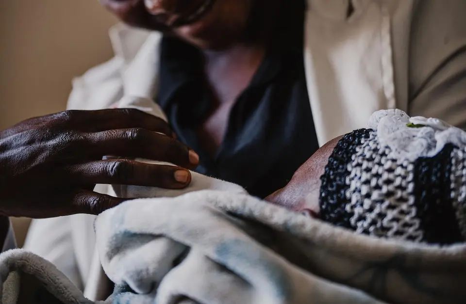 An 18-year-old mother of two cradles her infant daughter at a UNICEF-supported hospital in Bunia, Ituri province, DR Congo, on Nov. 25, 2025.