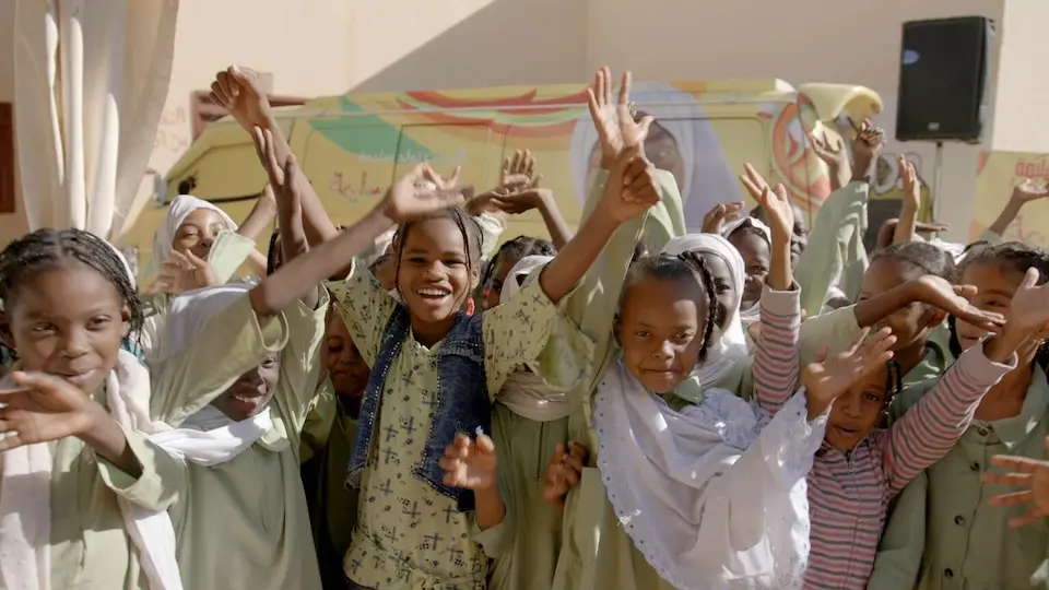 Young girls gather outside a Khartoum school to help advocate against FGM.