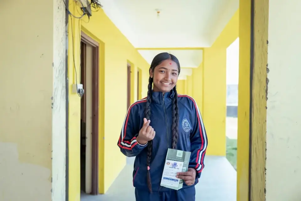 In Nepal, a 16-year-old girl Nepal poses after receiving the HPV vaccine.
