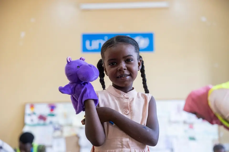 A 5-year-old plays with a puppet at the UNICEF-supported Saleh Jameel child friendly space in Khartoum state, Sudan..