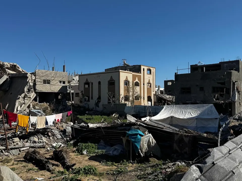 On Jan. 11, 2026, a makeshift tent stands among damaged buildings in Al Manshiya camp, Beit Lahia in North Gaza.