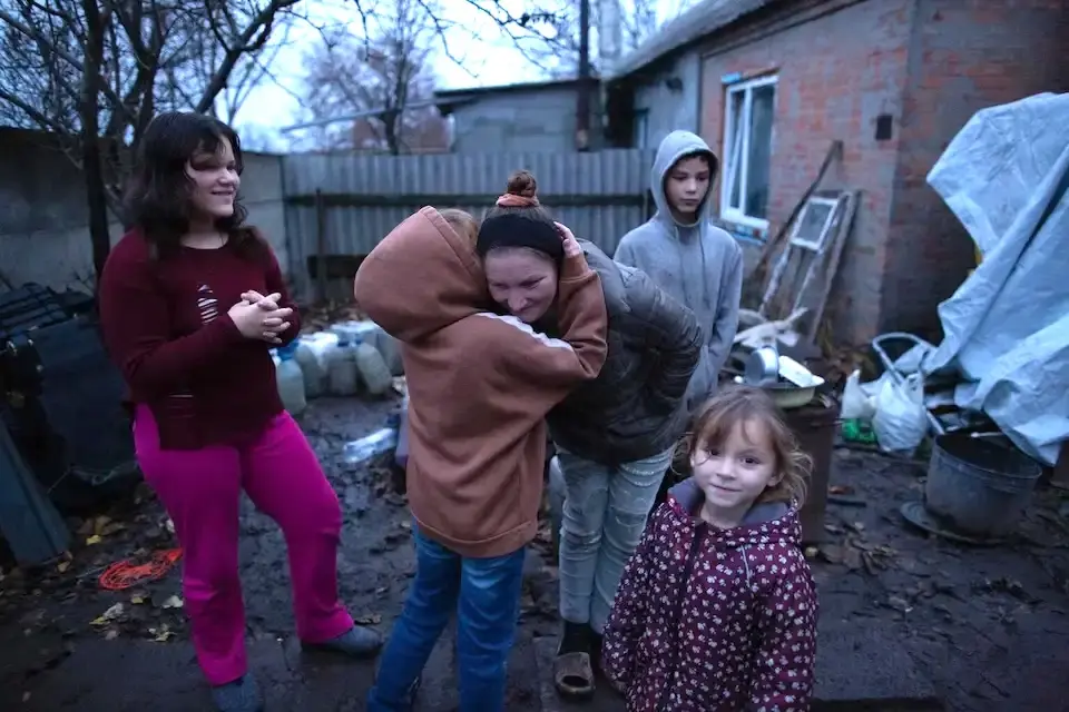 A mother and four of her children in the yard of the house where they live in eastern Ukraine.