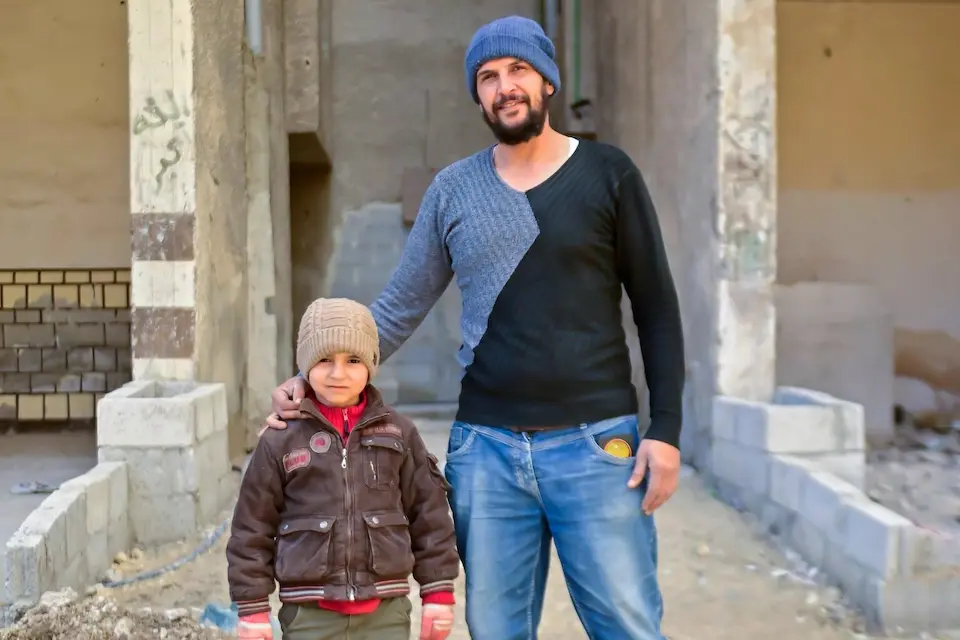 A father and son in the Tadamon neighborhood of Damascus, Syria, on Jan. 14, 2026.