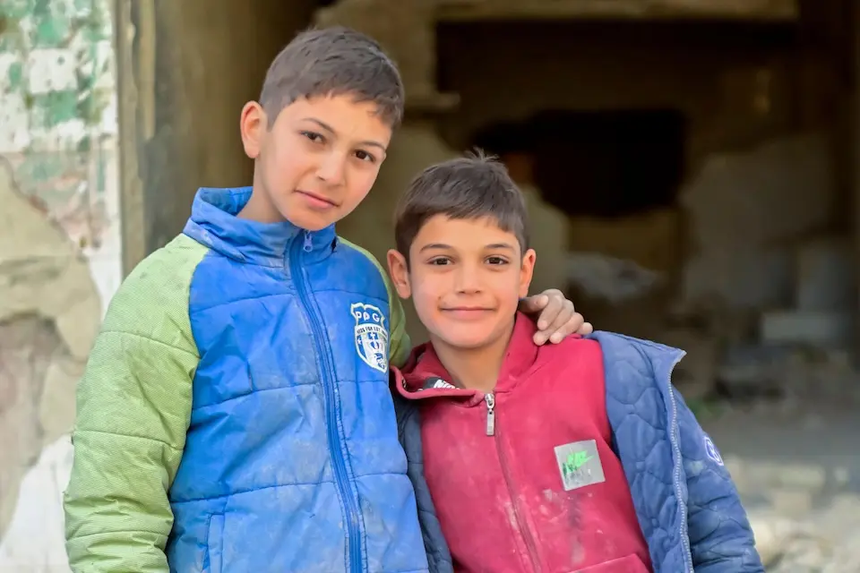 Brothers stand near their home in the Tadamon neighborhood of Damascus, Syria, on Jan. 14, 2026.
