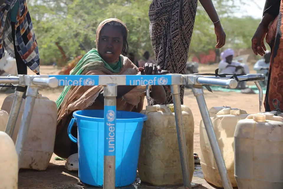 Children collect water from a UNICEF-installed water bladders in a refugee camp in Ennedi Est province, Chad.