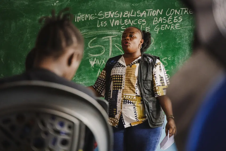 A woman facilitates a conversation at a UNICEF-supported, girl-only safe space in the Democratic Republic of the Congo