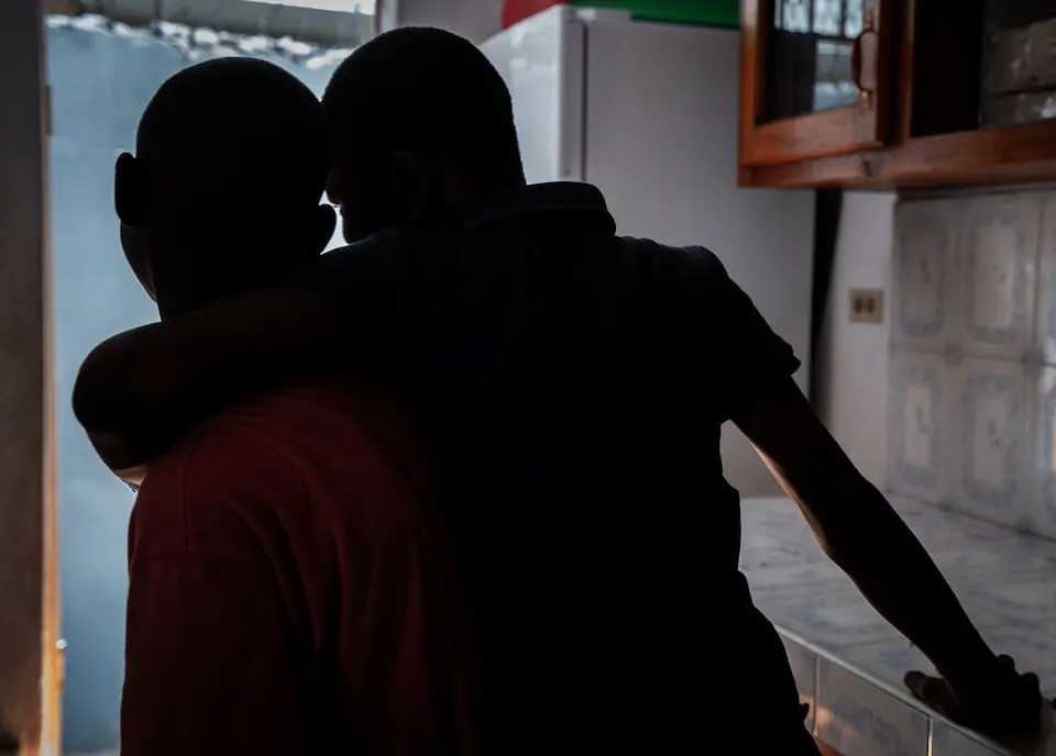Two boys support each other at a UNICEF-supported protection center in Haiti.