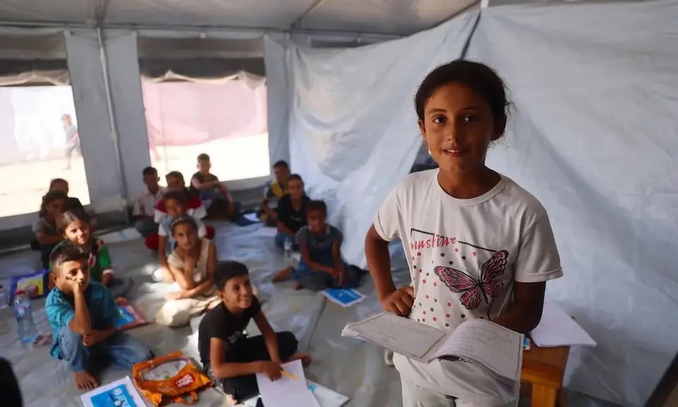 Lana, 10, learns alongside classmates in a UNICEF-supported temporary school in Gaza.