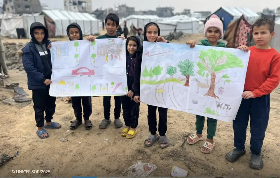 Palestinian children hold drawings they made to show their hopes for Gaza's future.