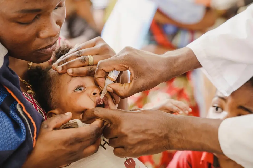 Altheis, 7-months old, receives a vaccine while held by her mother during a routine vaccination session in the Democratic Republic of the Congo. 