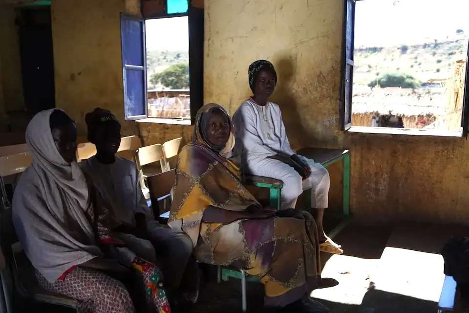 A teacher and students sit in a classroom of a UNICEF-supported school in Central Darfur, Sudan.