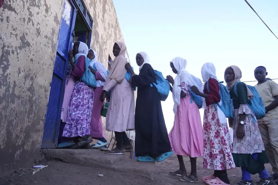 Students with UNICEF backpacks enter a school in Central Darfur, Sudan.