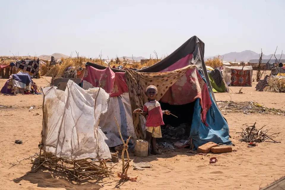 A child displaced by violence in Al Fasher stands in front of his family's makeshift shelter in Tawila, North Darfur, Sudan.
