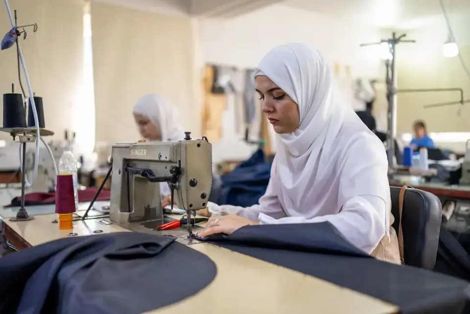 As part of UNICEF Lebanon's Learning to Earning program, a young woman sews blankets for children displaced by violence in March 2026. 