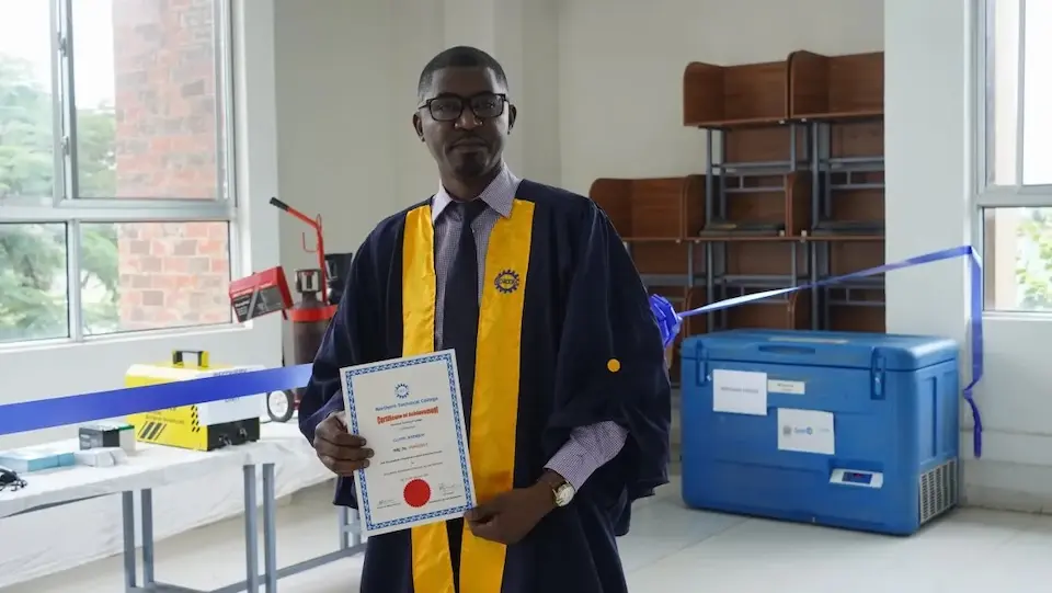 A provincial cold chain officer in Zambia holds his certificate showing he completed advanced training through a UNICEF-supported initiative.